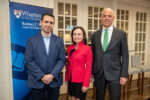 Joao Gomes, Sarah Hammer, and David Musto pose for a photo before a Rodney White Center banner