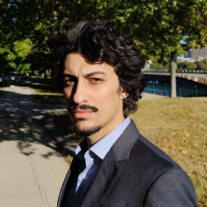 A person in a suit in an outdoor setting