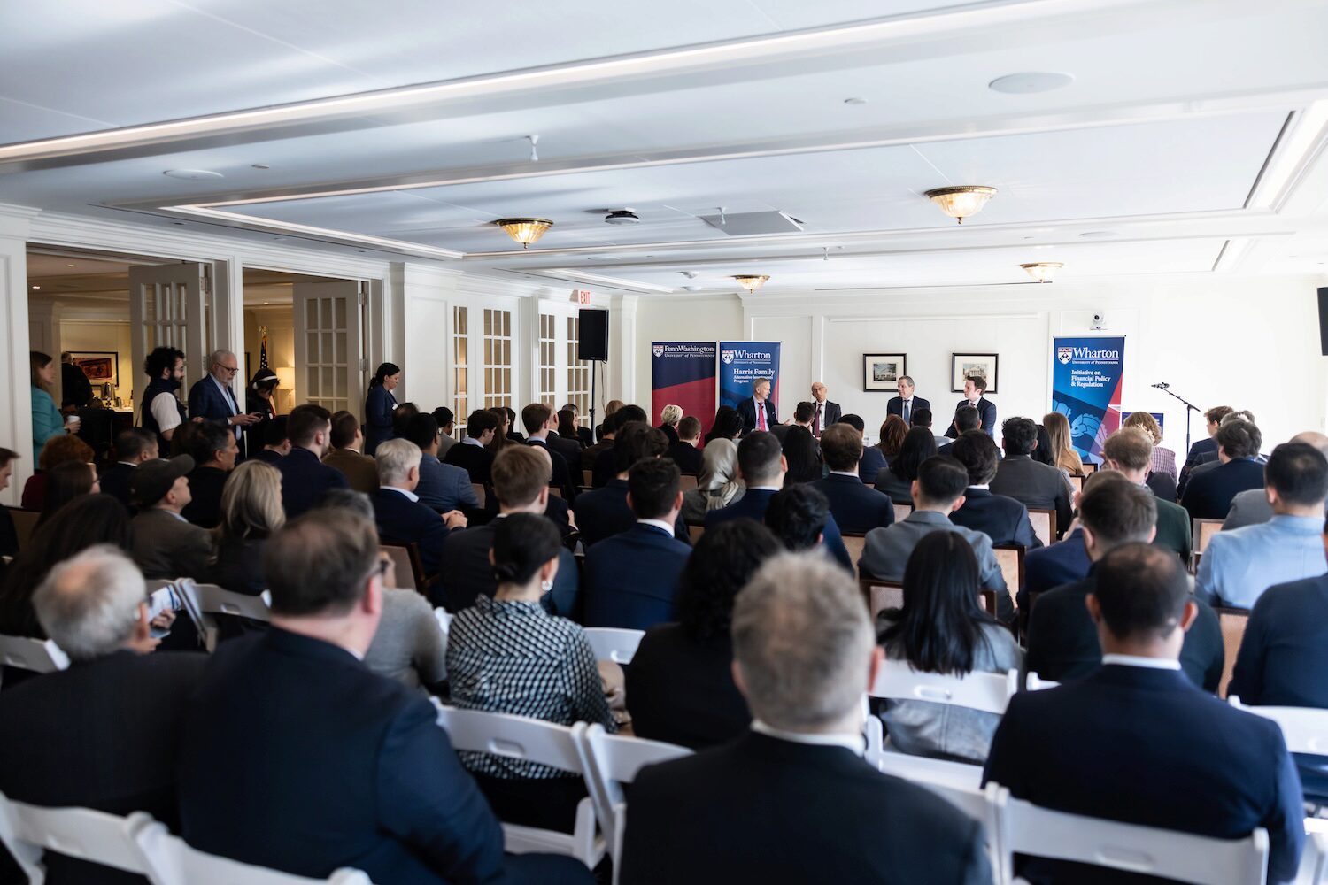 A conference audience watches a panel conversation