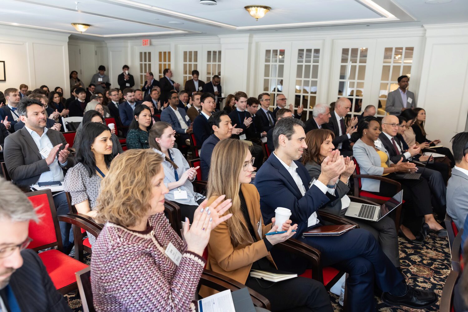 A full audience watches a conference