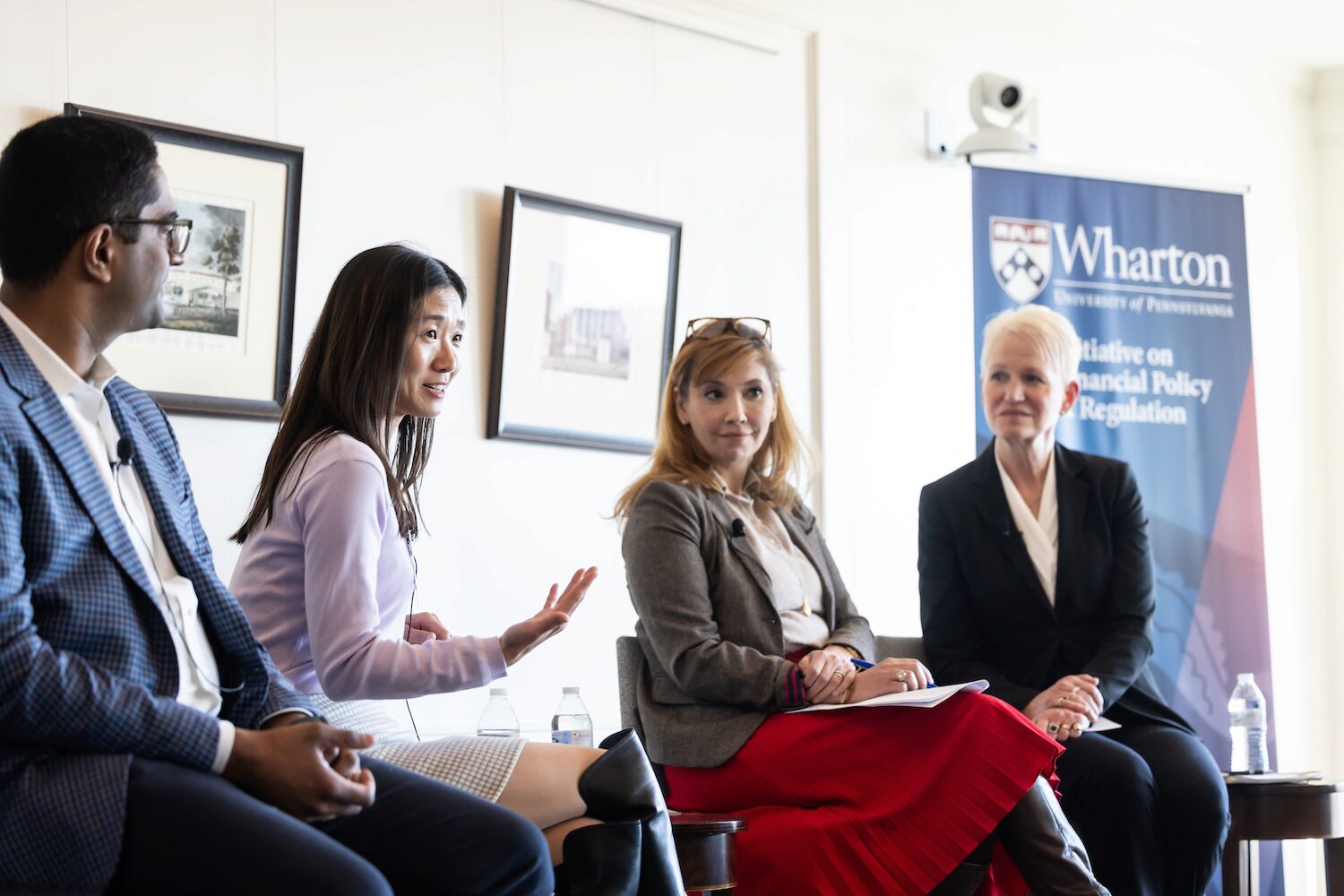 Four conference speakers in conversation
