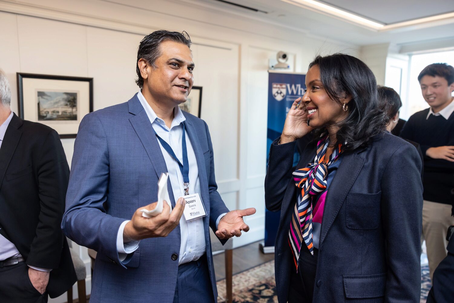 Two people in a candid conversation in a conference setting